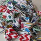 A collection of colorful sweetheart dog grooming bows with ribbon centers, displayed in varying colors including purple, green, and pink, with a polka dot pattern.